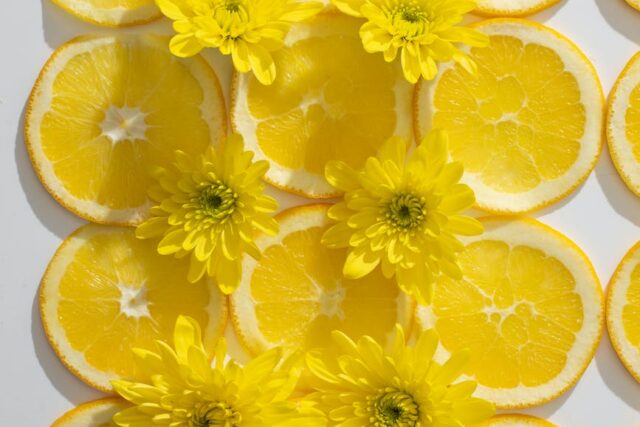 composition of orange slices and flowers