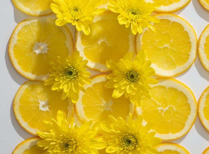 composition of orange slices and flowers